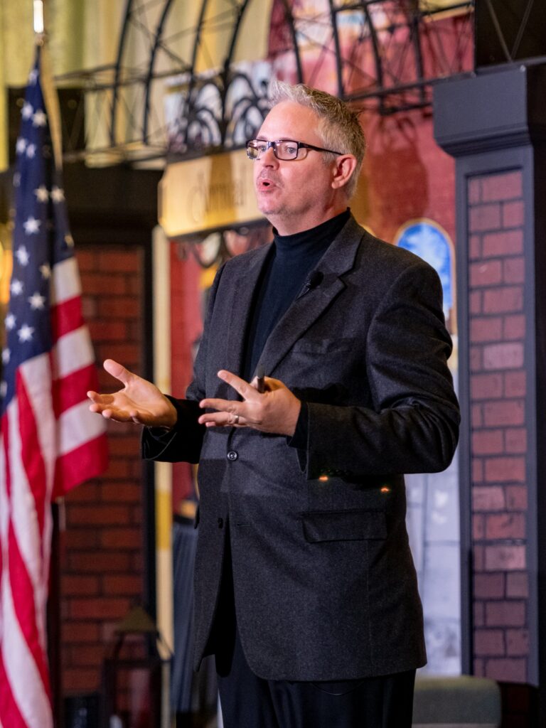 Tim Miles giving a keynote speech on company culture.