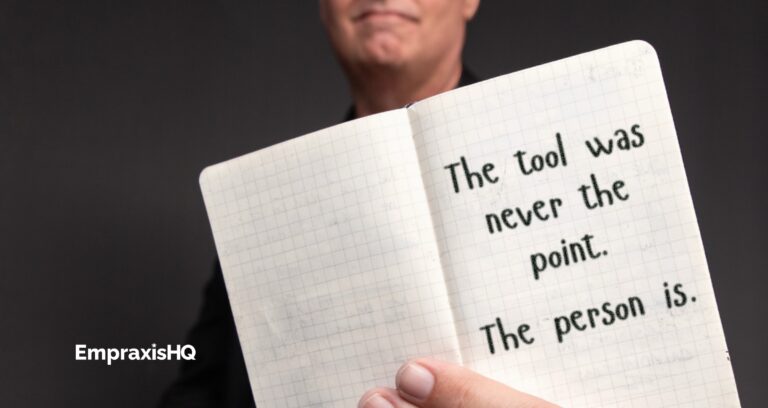 Tim Miles holding an open pocket notebook, on which is written "The tool was never the point. The person is"