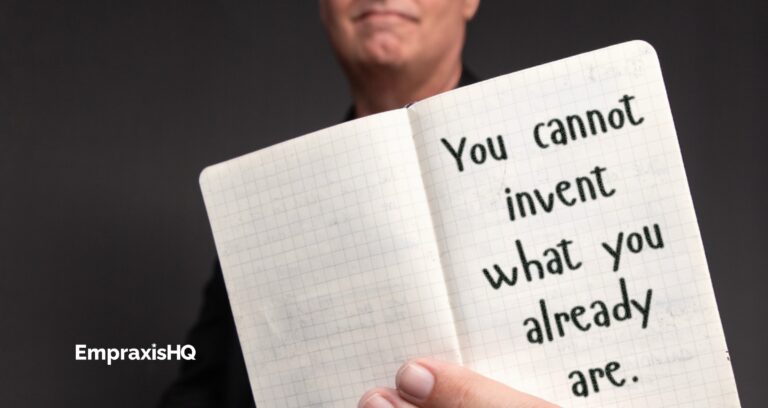 Tim Miles holding an open pocket notebook, on which is written "You cannot invent what you already are."